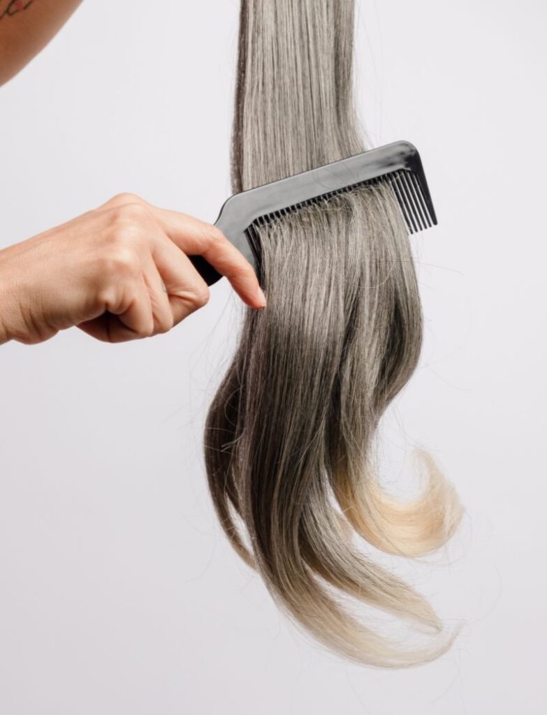 High Quality Human Hair Extensions Being Brushed For Extensions Application Service in Pembroke Pines Salon Hair Culture Day Spa